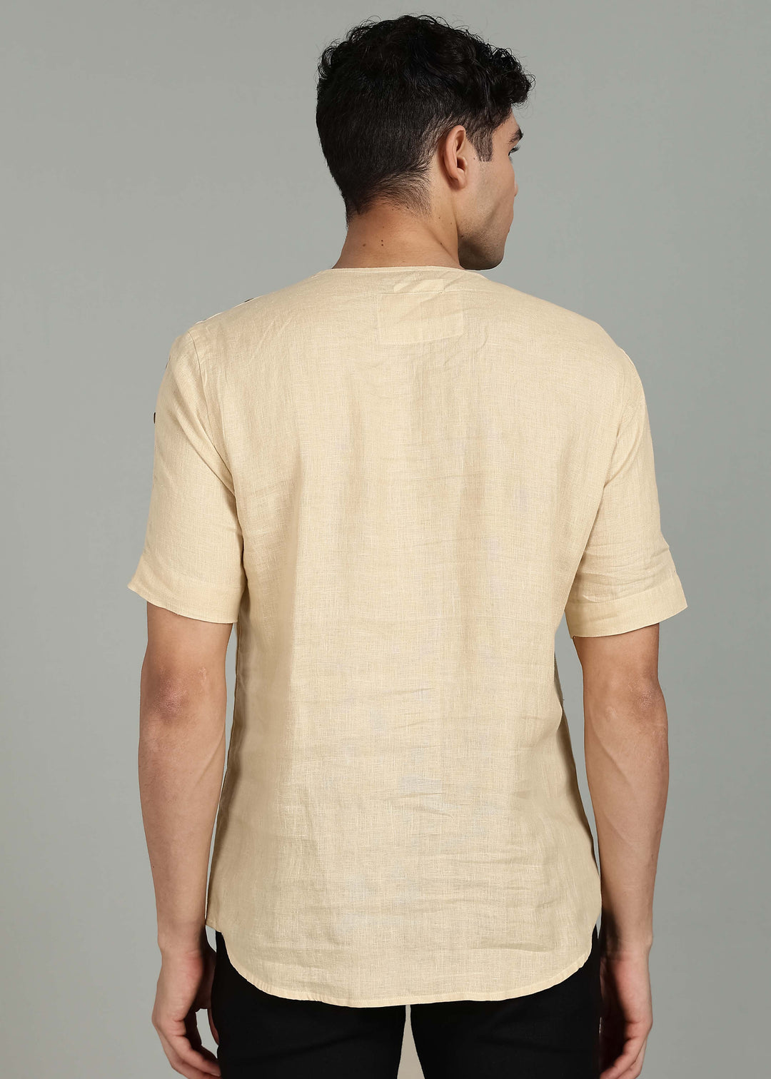 Man wearing 100% 60 LEA Light Tea Yellow Mandarin collar  T - Shirt in an indoor grey background.