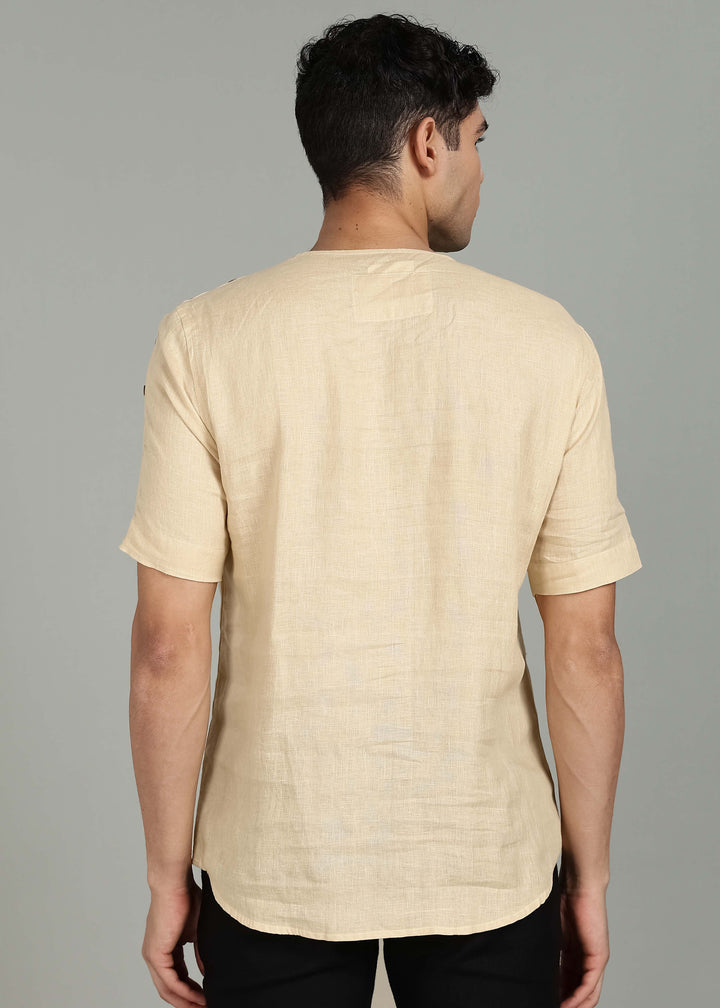Man wearing 100% 60 LEA Light Tea Yellow Mandarin collar  T - Shirt in an indoor grey background.