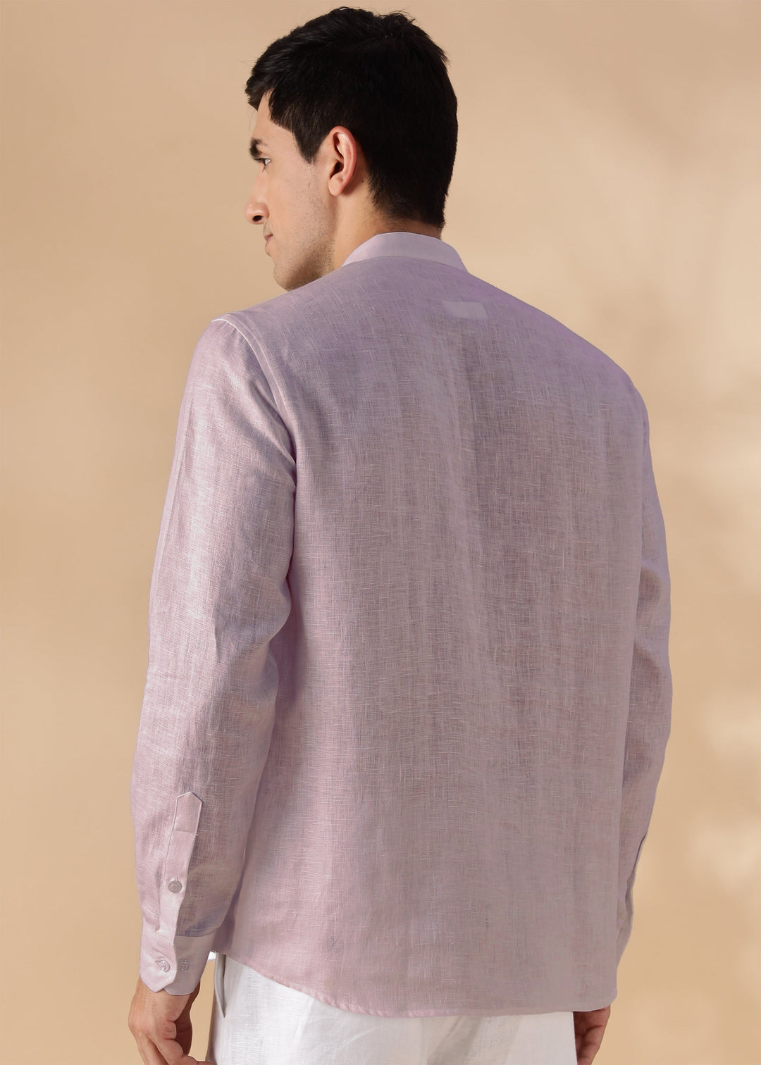 Man wearing a 100% pure linen cameo pink short kurta on a beige background