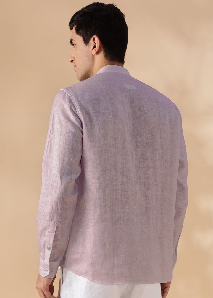Man wearing a 100% pure linen cameo pink short kurta on a beige background
