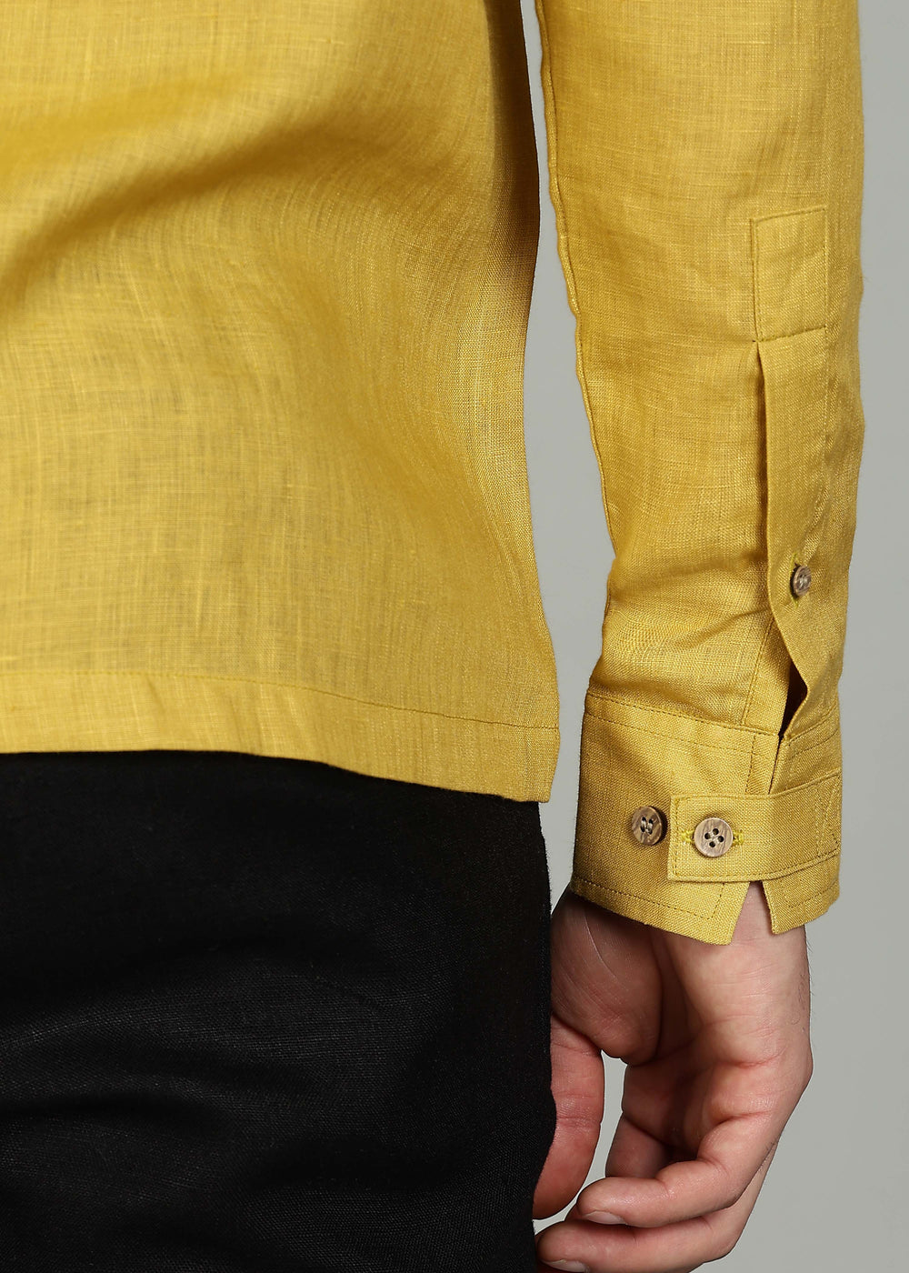 A 100% pure linen sunburst yellow full sleeve shirt in 60 LEA with rolled-up sleeve on a gray background