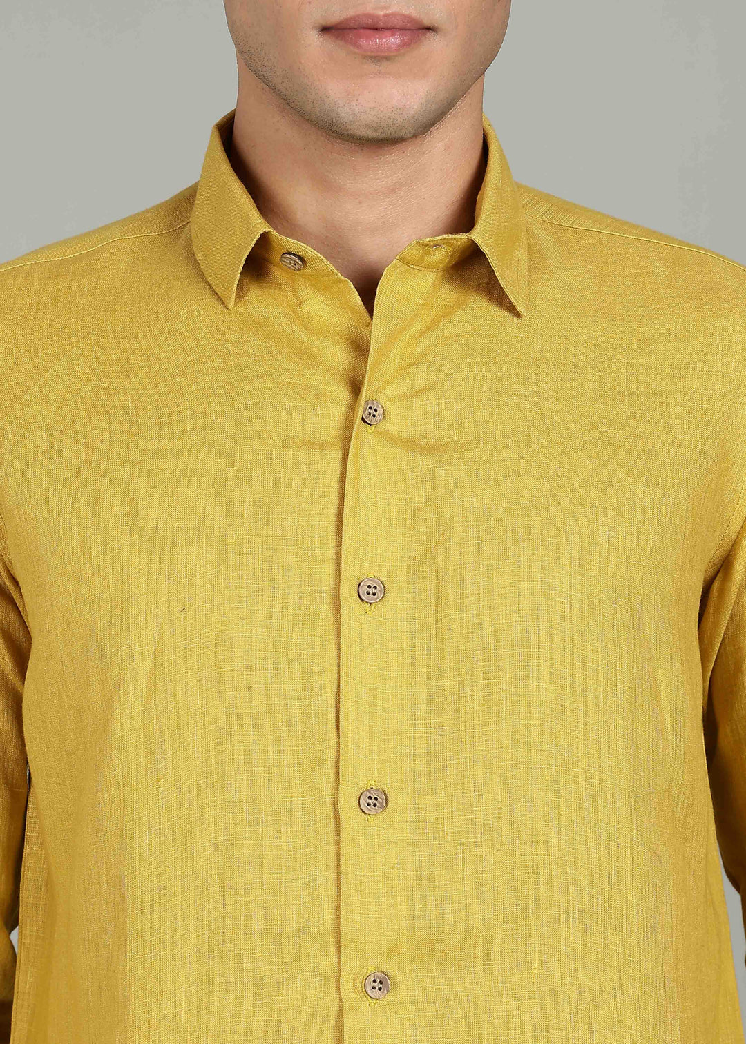 a 100% pure linen sunburst yellow full sleeve shirt in 60 LEA by a person on a gray background