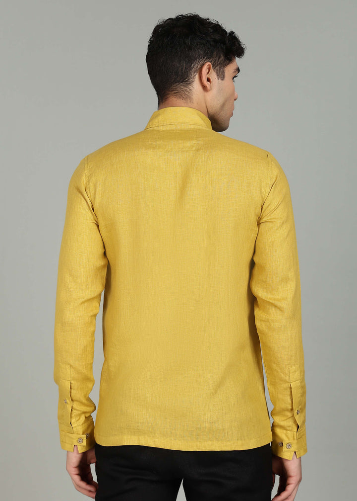 Man wearing a 100% pure linen sunburst yellow full sleeve shirt in 60 LEA against a gray background