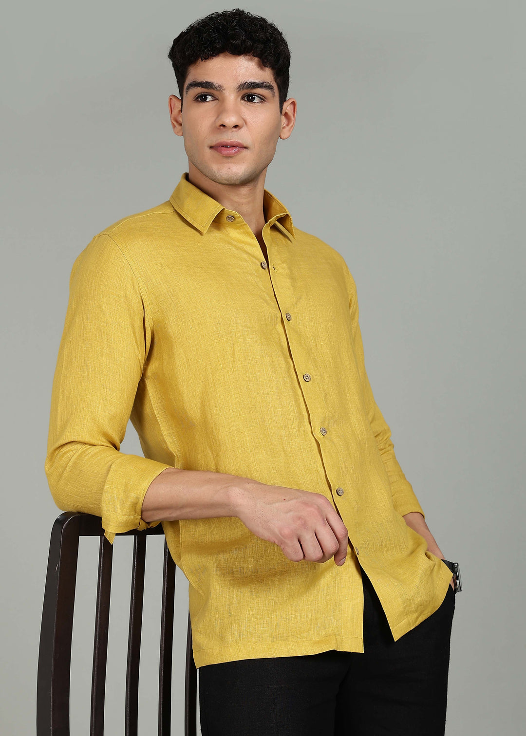 Man wearing a 100% pure linen sunburst yellow full sleeve shirt in 60 LEA against a gray background