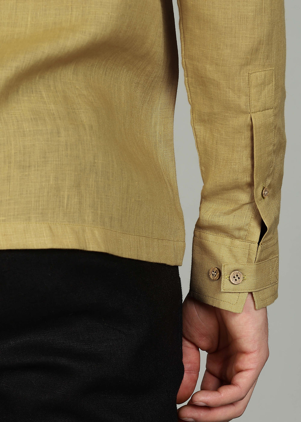 Man wearing a 100% pure linen sunburst yellow full sleeve shirt in 60 LEA against a gray background