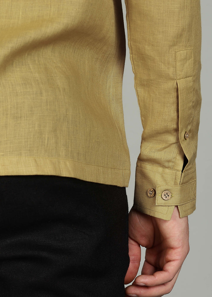 Man wearing a 100% pure linen sunburst yellow full sleeve shirt in 60 LEA against a gray background