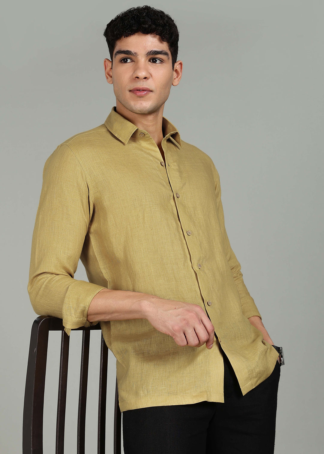 Man wearing a 100% pure linen sunburst yellow full sleeve shirt in 60 LEA against a gray background