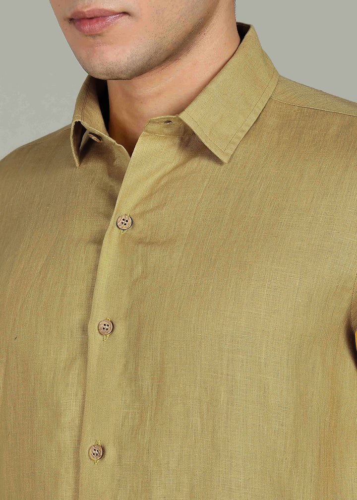 Man wearing a 100% pure linen sunburst yellow full sleeve shirt in 60 LEA against a gray background