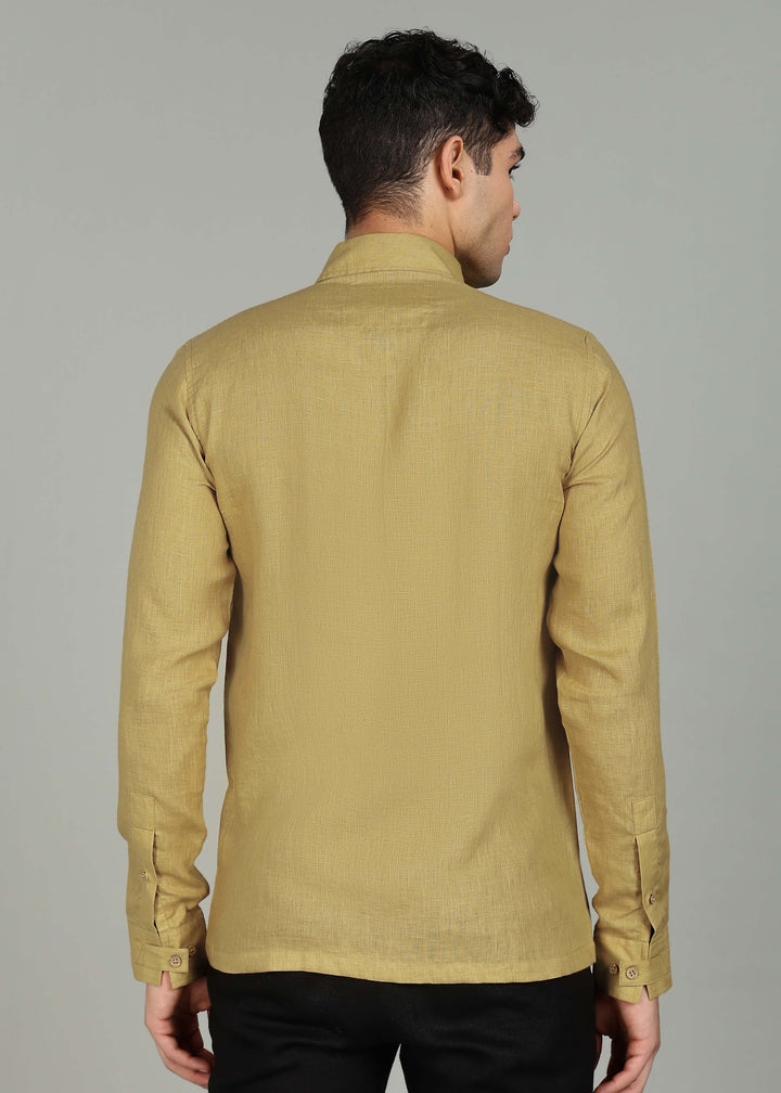 Man wearing a 100% pure linen sunburst yellow full sleeve shirt in 60 LEA against a gray background