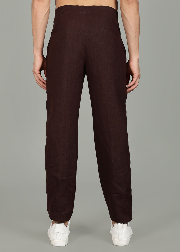 Man wearing 100% 25 LEA Cocoa Brown formal pants in an indoor grey background.