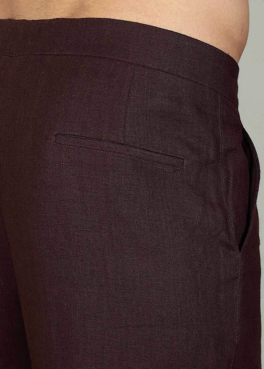 Man wearing 100% 25 LEA Cocoa Brown formal pants in an indoor grey background.