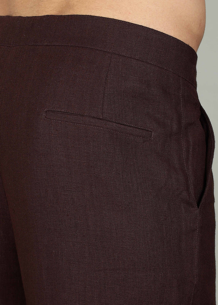 Man wearing 100% 25 LEA Cocoa Brown formal pants in an indoor grey background.