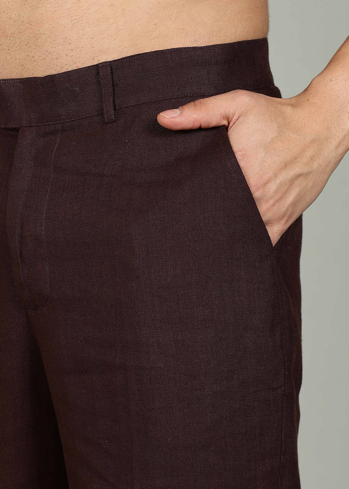 Man wearing 100% 25 LEA Cocoa Brown formal pants in an indoor grey background.