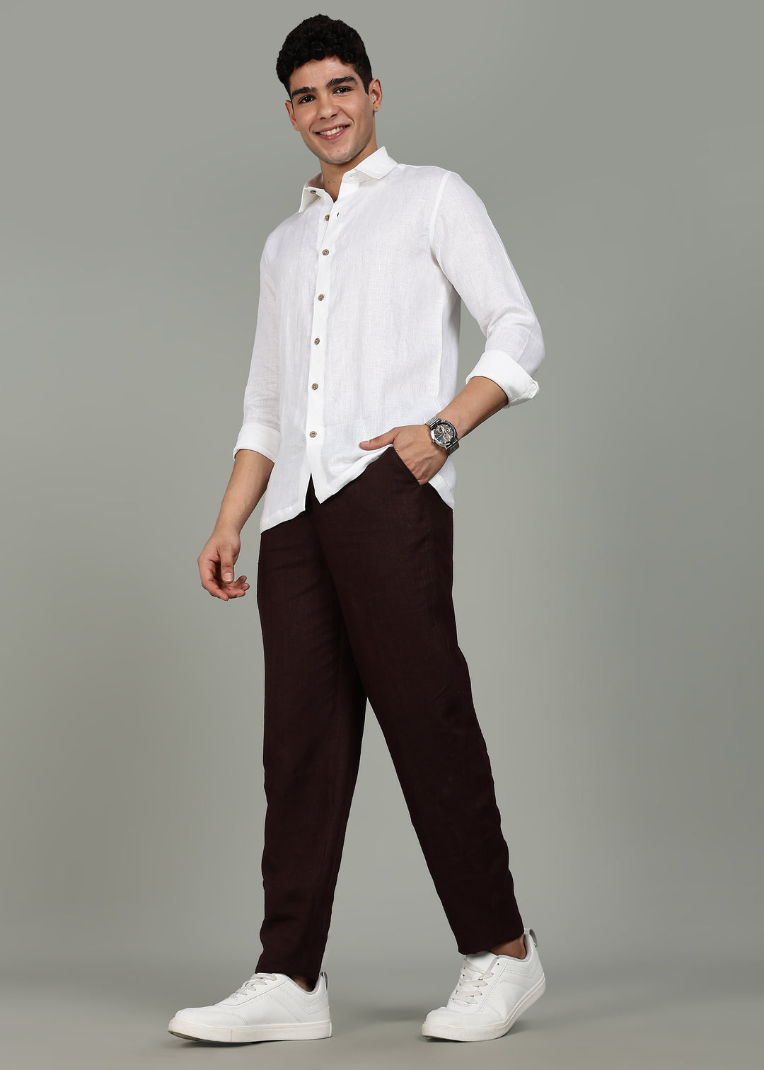 Man wearing 100% 25 LEA Cocoa Brown formal pants in an indoor grey background.