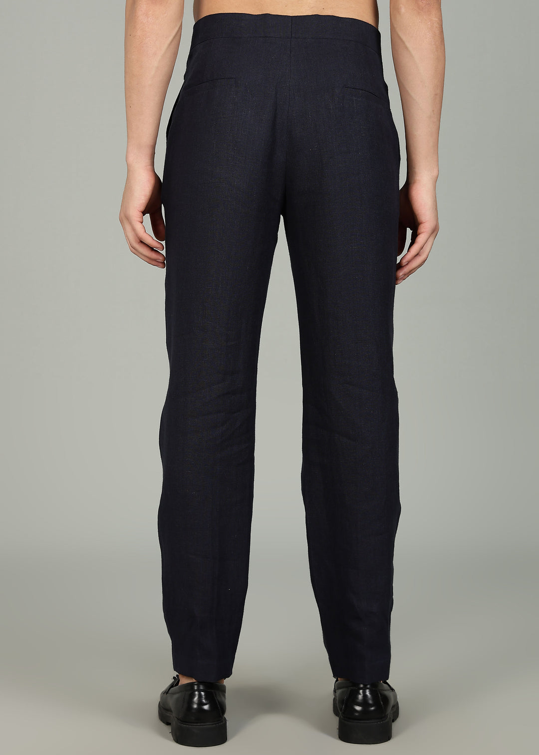 Man wearing 100% 25 LEA Regal Blue formal pants in an indoor grey background.