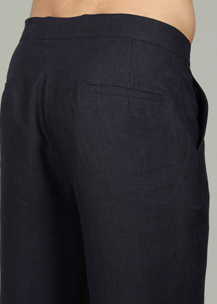 Man wearing 100% 25 LEA Regal Blue formal pants in an indoor grey background.