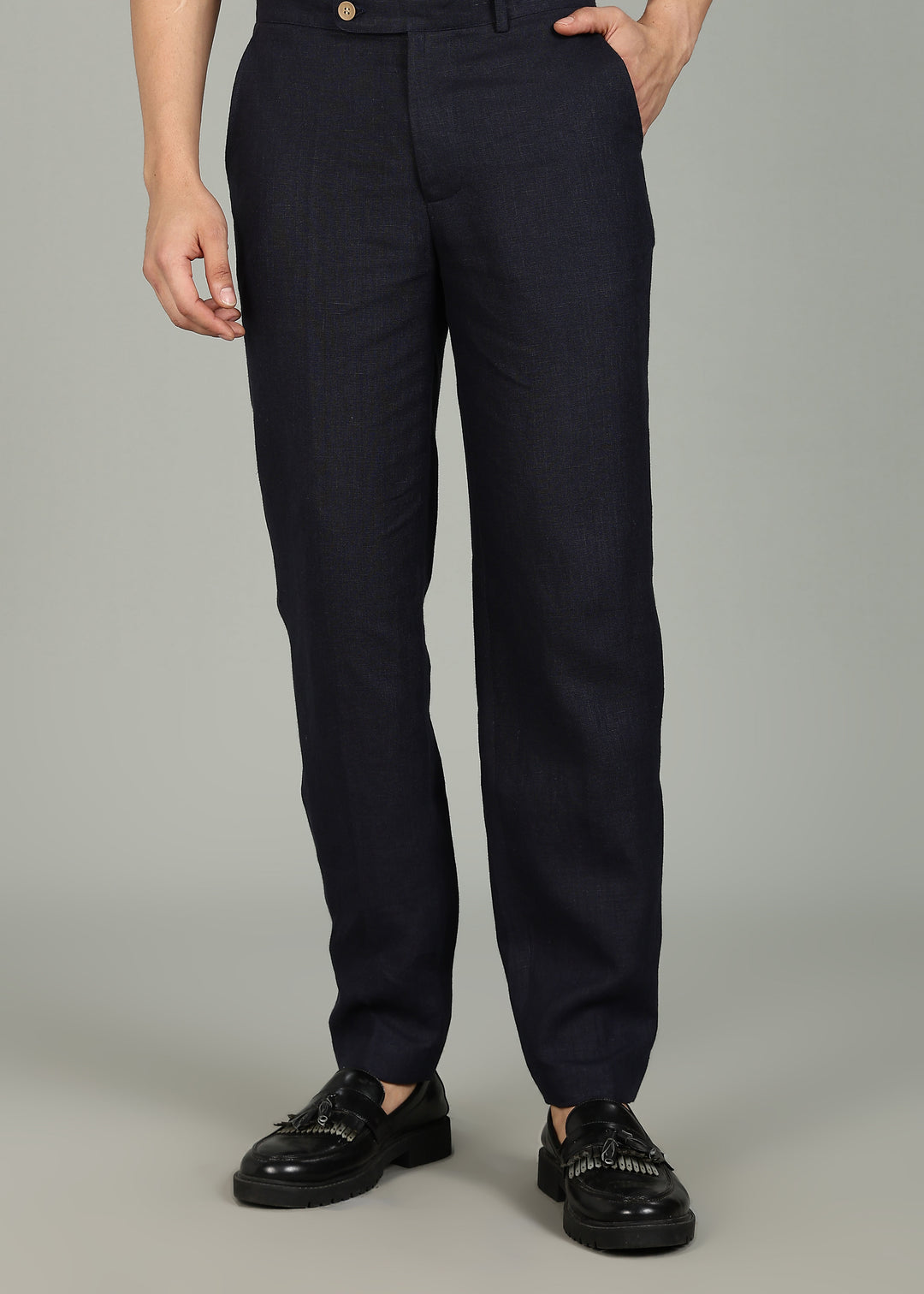 Man wearing 100% 25 LEA Regal Blue formal pants in an indoor grey background.