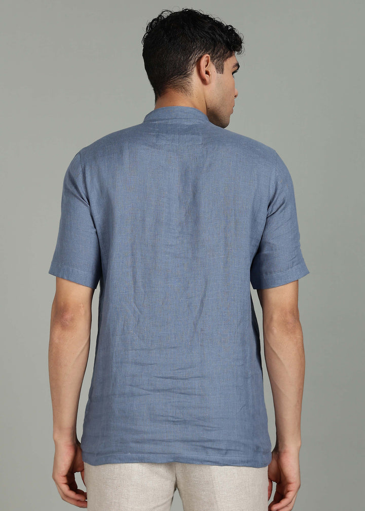 Man wearing 100% 60 LEA Blue grey Half sleeve Shirt in an indoor grey background.