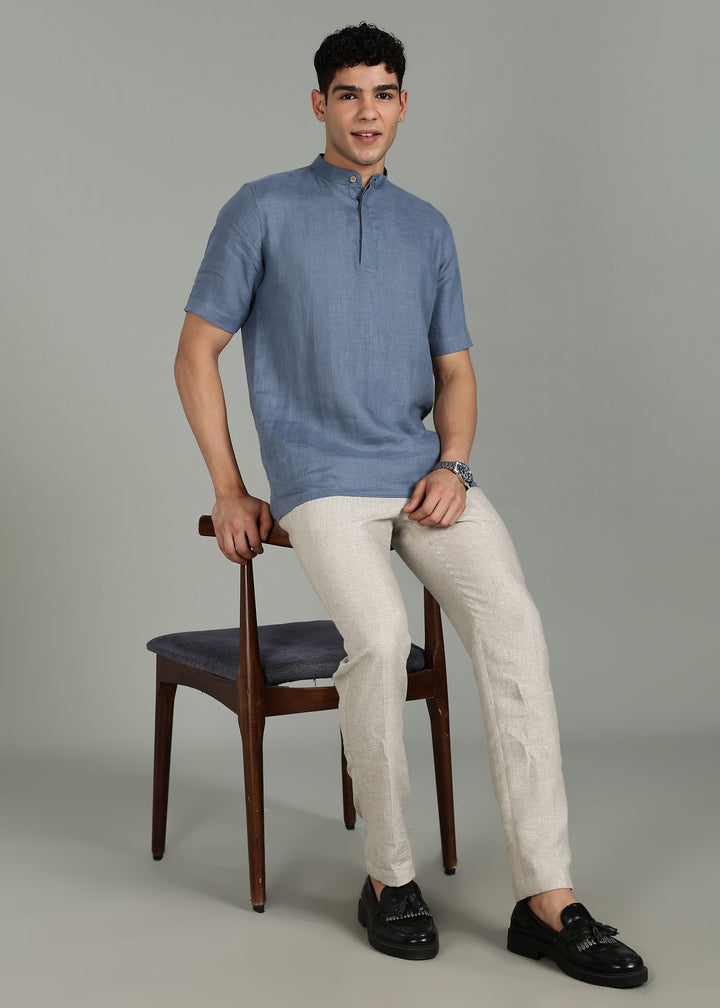 Man wearing 100% 60 LEA Blue grey Half sleeve Shirt in an indoor grey background.