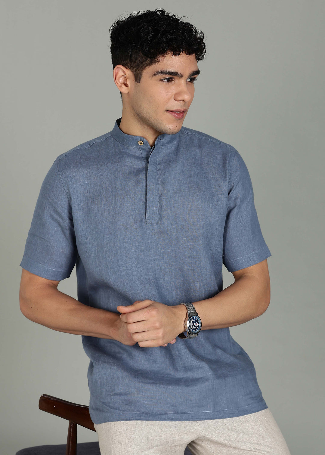 Man wearing 100% 60 LEA Blue grey Half sleeve Shirt in an indoor grey background.