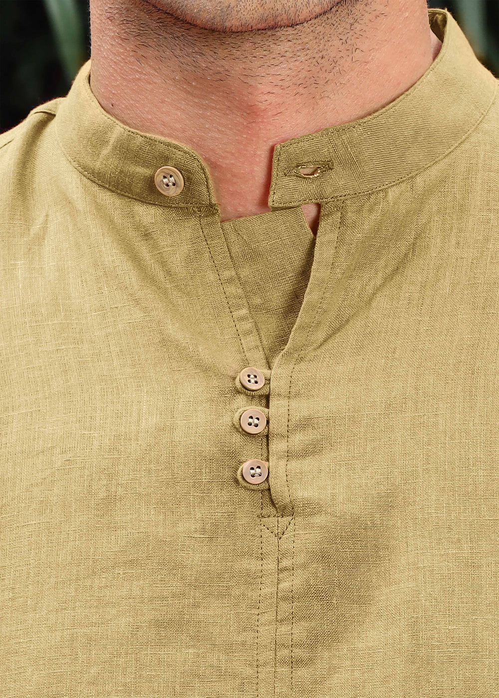 A man wearing a 100% pure linen 60 LEA long-sleeve sunburst yellow pure linen kurta with a mandarin collar.