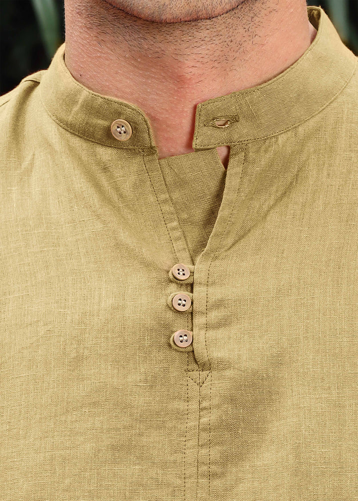 A man wearing a 100% pure linen 60 LEA long-sleeve sunburst yellow pure linen kurta with a mandarin collar.
