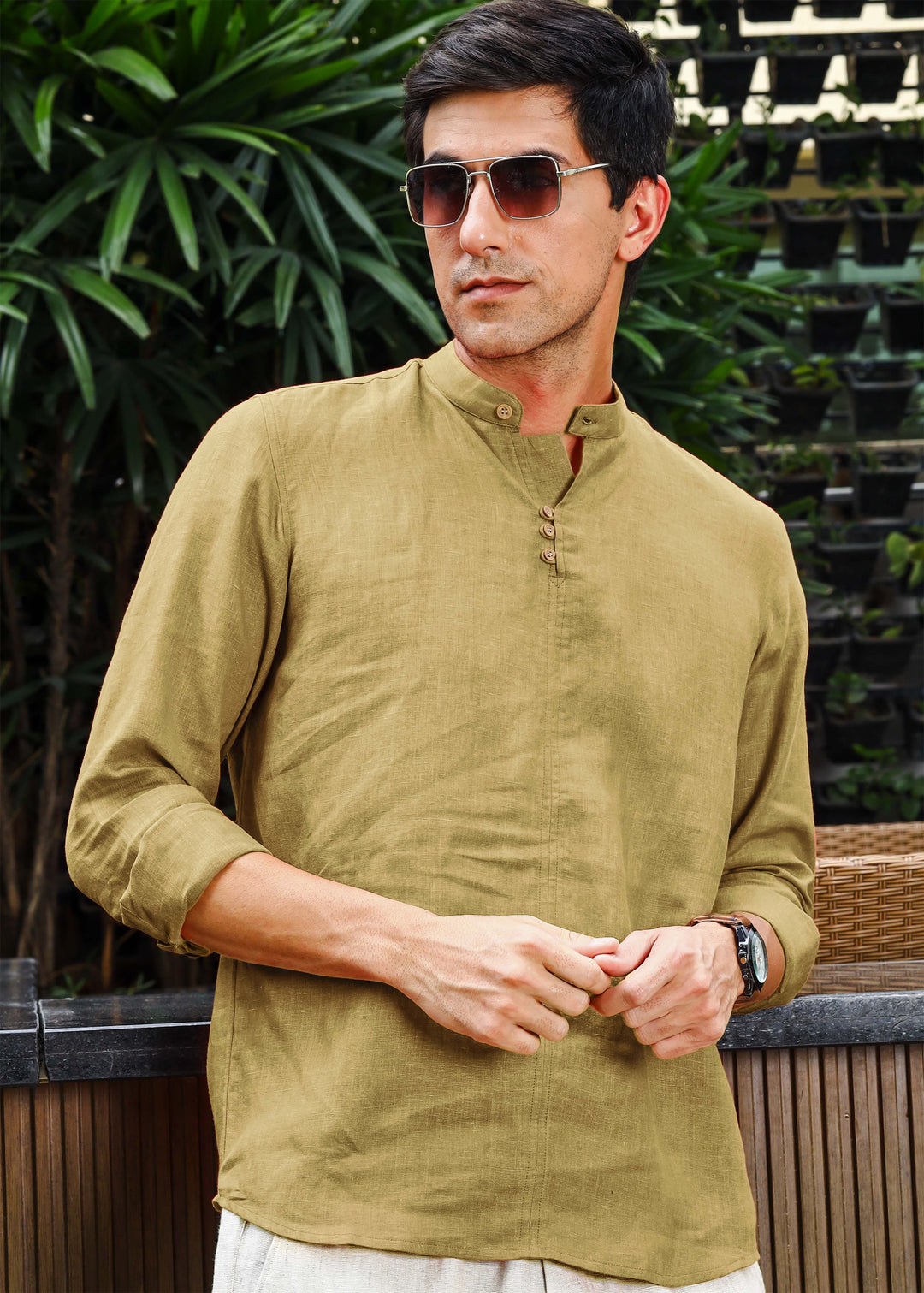 A man wearing a 100% pure linen 60 LEA long-sleeve sunburst yellow pure linen kurta with a mandarin collar.