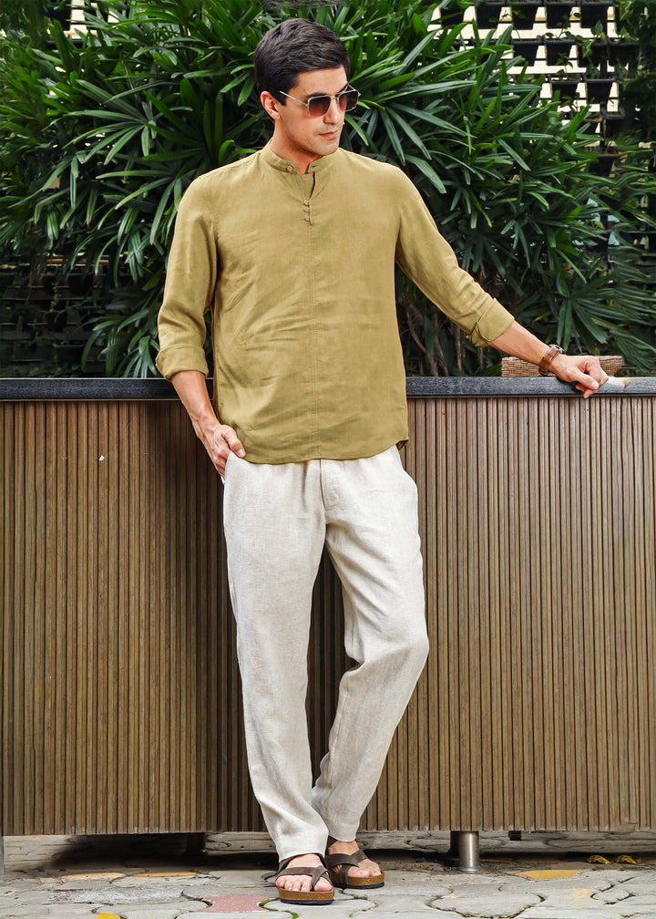A man wearing a 100% pure linen 60 LEA long-sleeve sunburst yellow pure linen kurta with a mandarin collar.