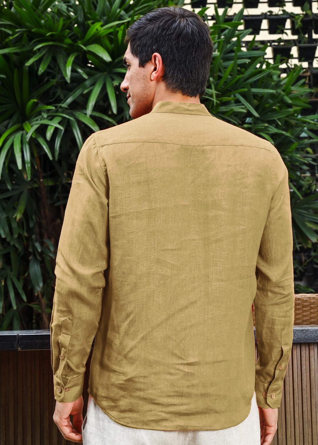 A man wearing a 100% pure linen 60 LEA long-sleeve sunburst yellow pure linen kurta with a mandarin collar.