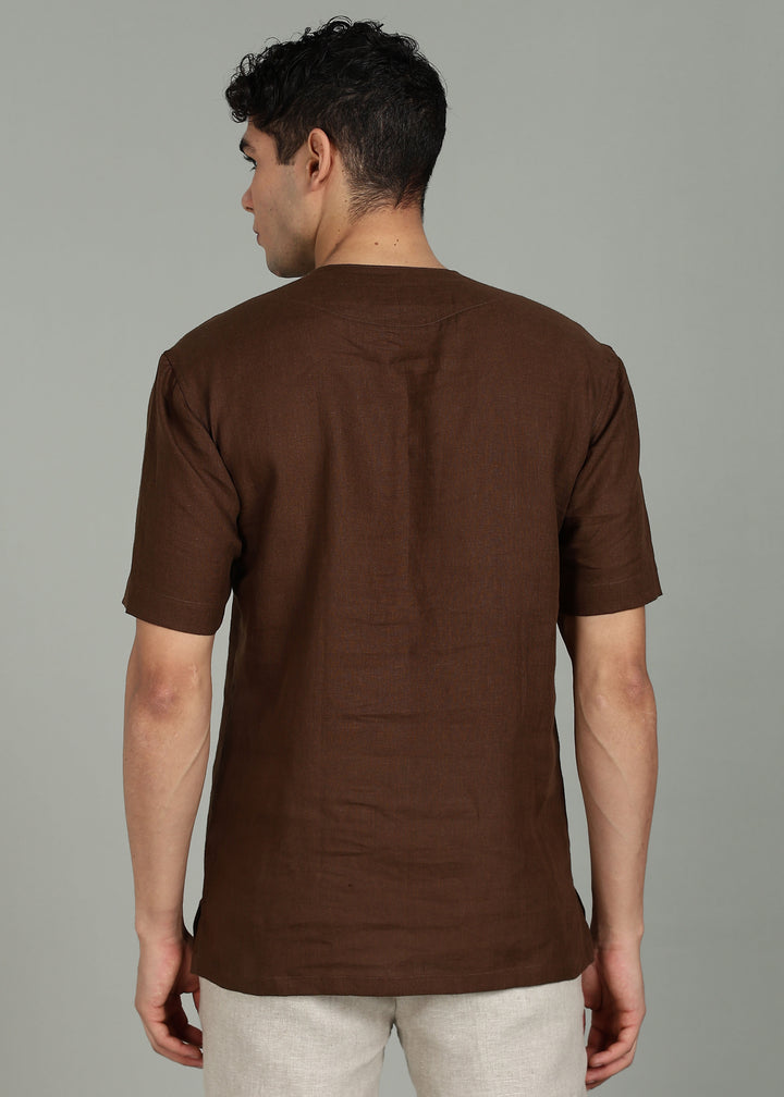 Man wearing 100% 60 LEA Coffee Brown Baseball collar T - Shirt in an indoor grey background.