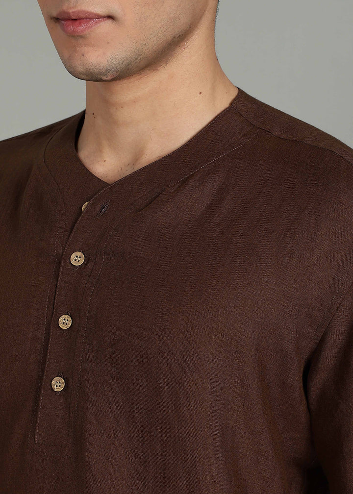 Man wearing 100% 60 LEA Coffee Brown Baseball collar T - Shirt in an indoor grey background.