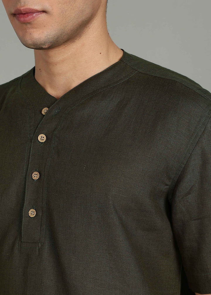 Man wearing 100% 60 LEA Moss Green Baseball collar T - Shirt in an indoor grey background.