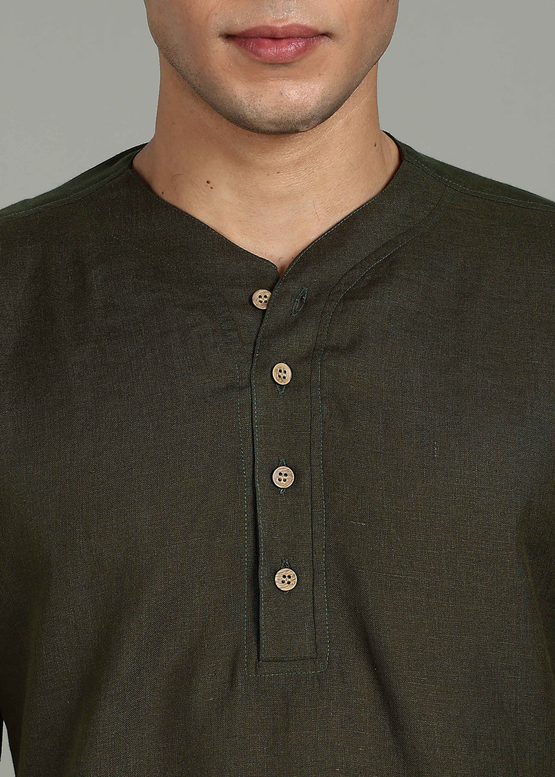 Man wearing 100% 60 LEA Moss Green Baseball collar T - Shirt in an indoor grey background.