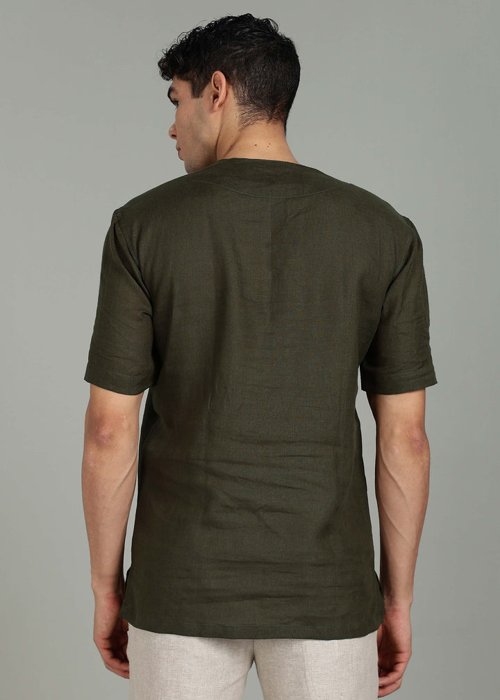Man wearing 100% 60 LEA Moss Green Baseball collar T - Shirt in an indoor grey background.