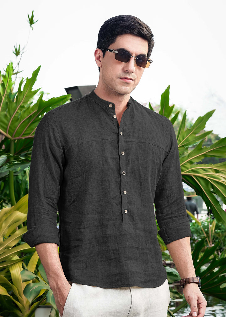 Man wearing a 100% pure linen black short kurta with sunglasses in a garden setting