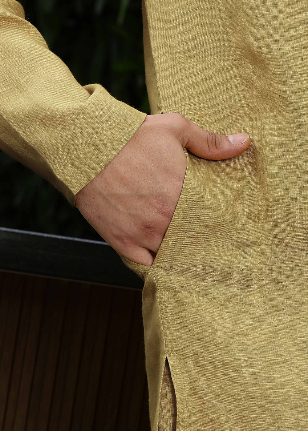 Man wearing a 100% Sunburst yellow 60 lea Kurta, with placket detail, in a Green outdoor Background.