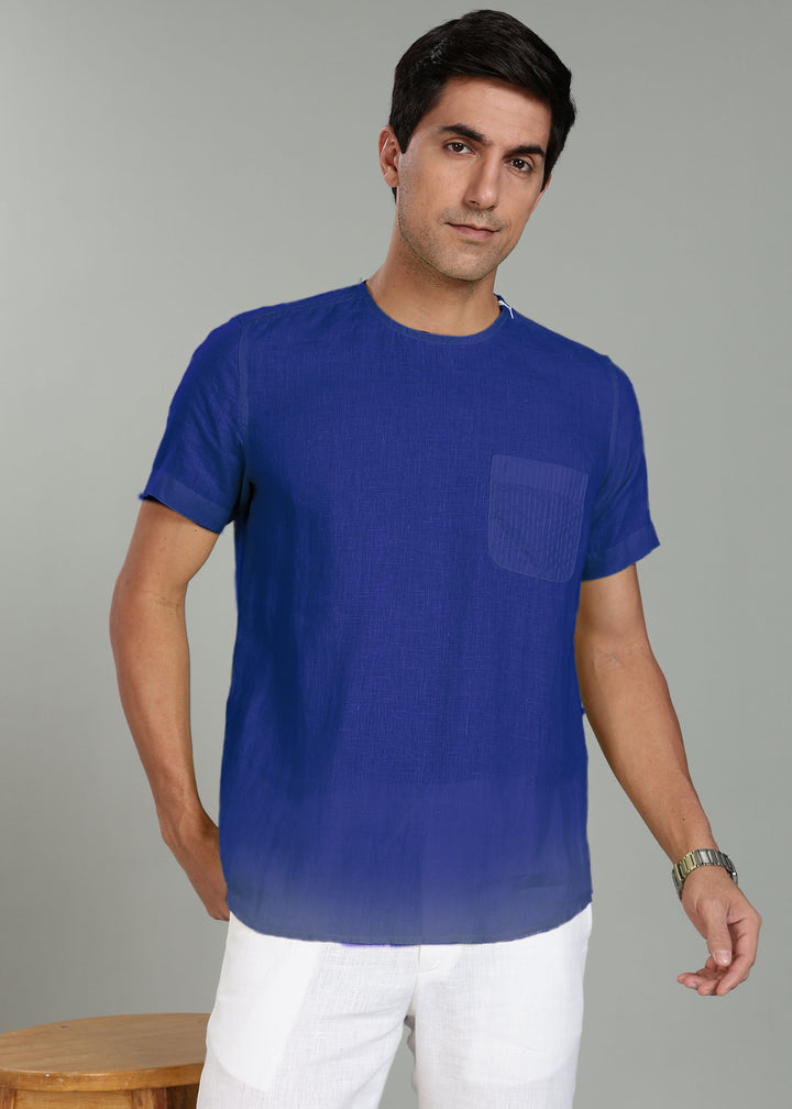 Man wearing a 100% pure linen egyptian blue t-shirt with a pocket on a gray background