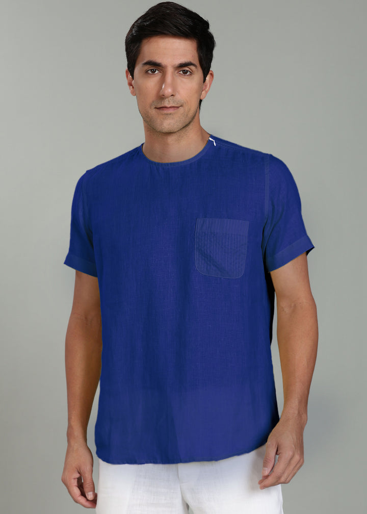 Man wearing a 100% pure linen  egyptian blue t-shirt with a pocket on a gray background