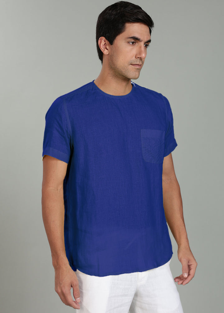 Man wearing a 100% pure linen egyptian blue t-shirt with a pocket on a gray background