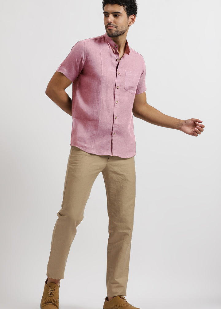 Man wearing a 100% pure linen hermosa pink shirt and light hazelnut brown pants on a white background