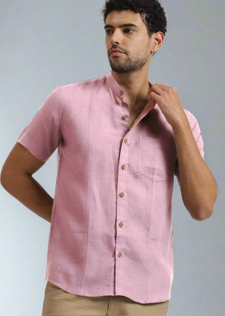 Man wearing 100% pure linen hermosa pink shirt against a gray background
