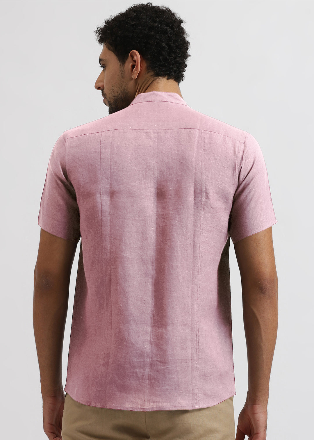 Man wearing 100% pure linen hermosa pink shirt on a light gray background