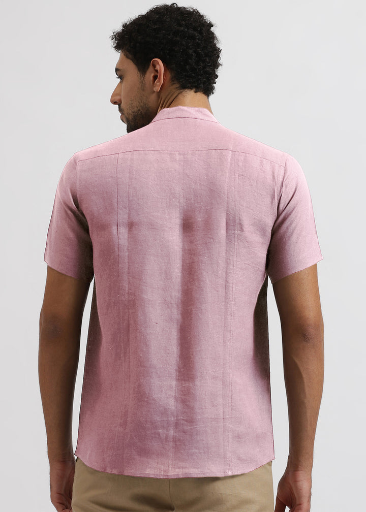 Man wearing 100% pure linen hermosa pink shirt on a light gray background