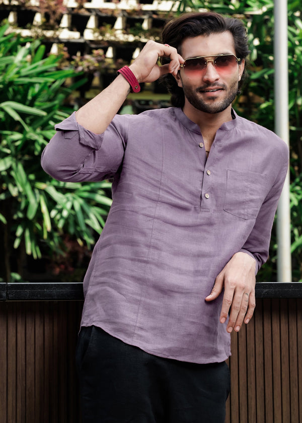 A man wearing a misty lilac, half placket, full sleeve pure linen shirt with a mandarin collar.