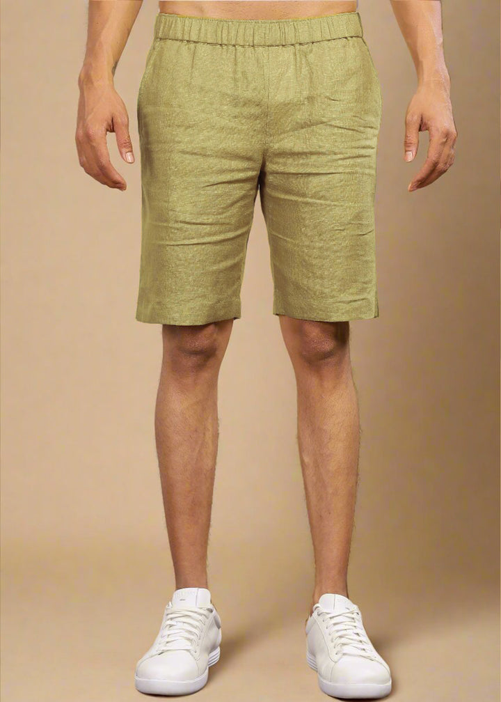 A pair of sunburst yellow pure linen shorts with an elastic band, displayed on a model