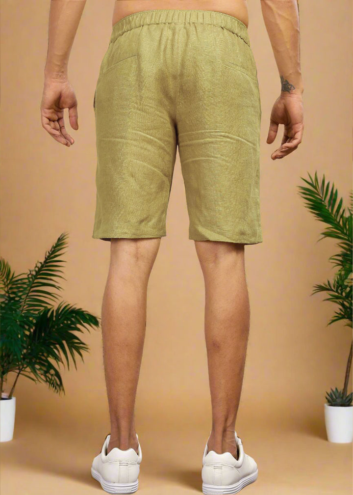 A pair of sunburst yellow pure linen shorts with an elastic band, displayed on a model