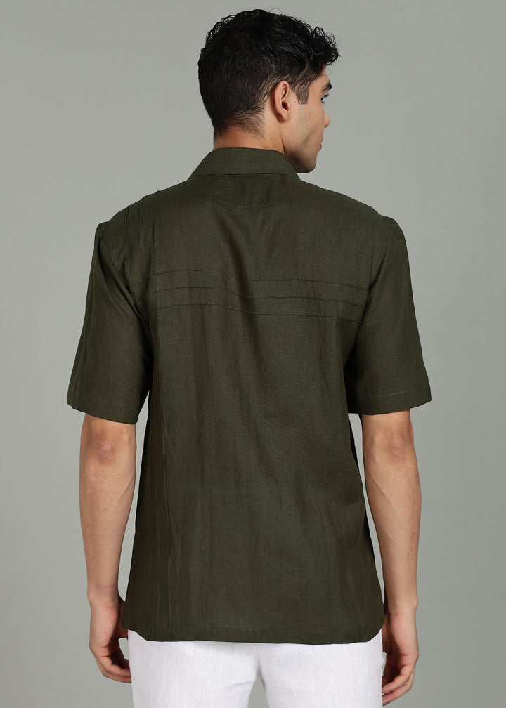 Man wearing 100% 60 LEA Moss Green Cuban collar Half sleeve Shirt in an indoor grey background.