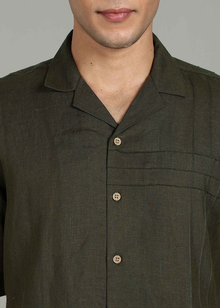 Man wearing 100% 60 LEA Moss Green Cuban collar Half sleeve Shirt in an indoor grey background.