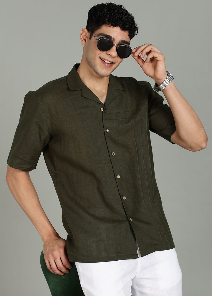 Man wearing 100% 60 LEA Moss Green Cuban collar Half sleeve Shirt in an indoor grey background.