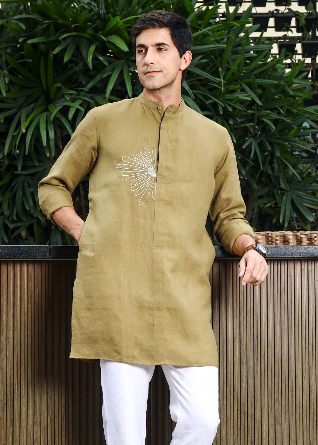 Man wearing a 100% pure linen 60 LEA sunburst yellow kurta against a green leafy background
